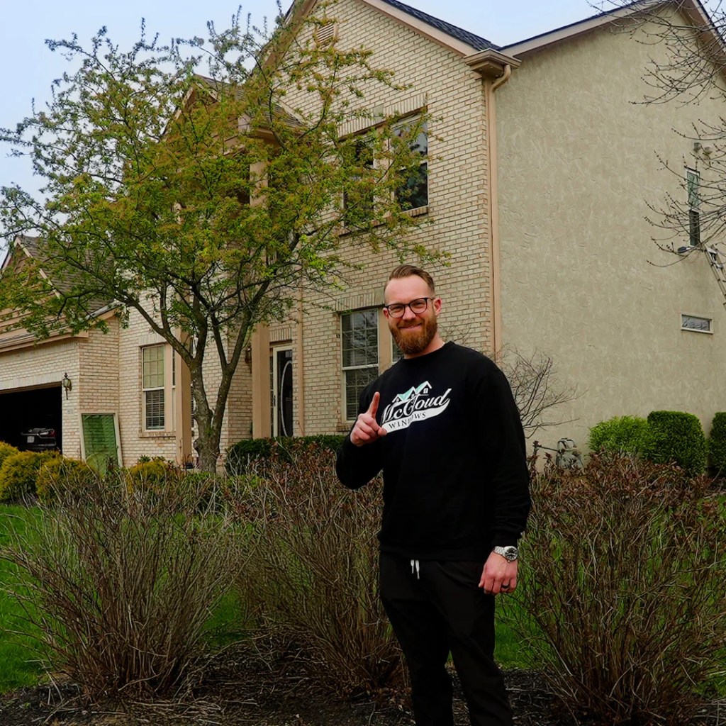 owner of virtual view windows standing behind of a finished window replacement service
