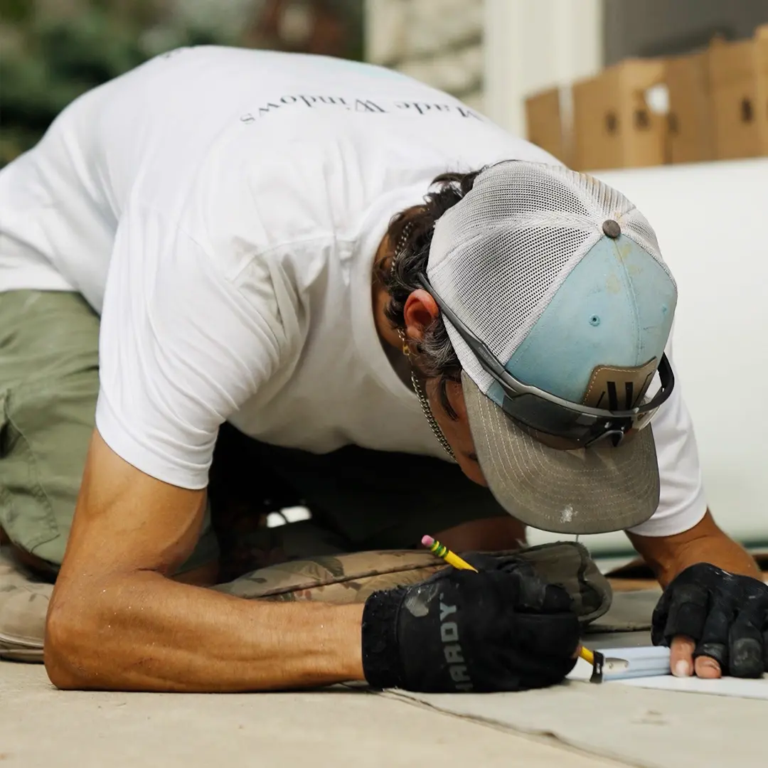 Window contractor conducting measurements