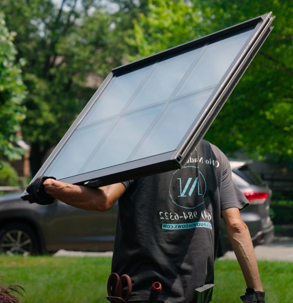 Brad carrying a black window panel