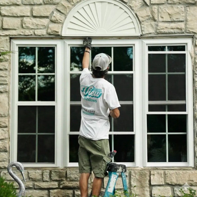 Window installer in white clothes doing window installation